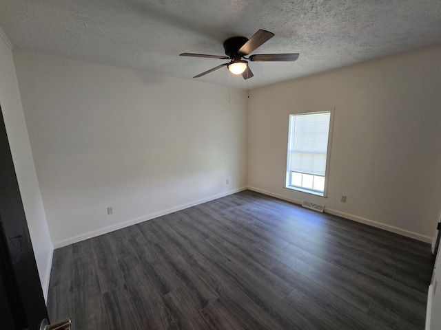 empty room with baseboards, dark wood-style floors, a textured ceiling, and ceiling fan