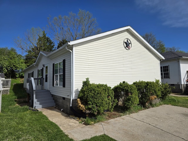 view of home's exterior featuring a lawn and crawl space