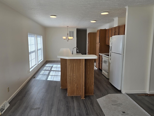 kitchen featuring brown cabinetry, white appliances, light countertops, a notable chandelier, and visible vents