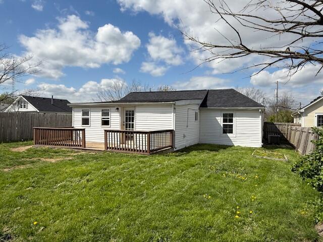 back of house featuring a yard, a fenced backyard, and a wooden deck