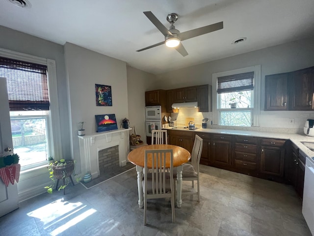 142 Old Lafayette Ave, Lexington, KY 40502 - kitchen featuring under cabinet range hood, light countertops, plenty of natural light, and decorative backsplash