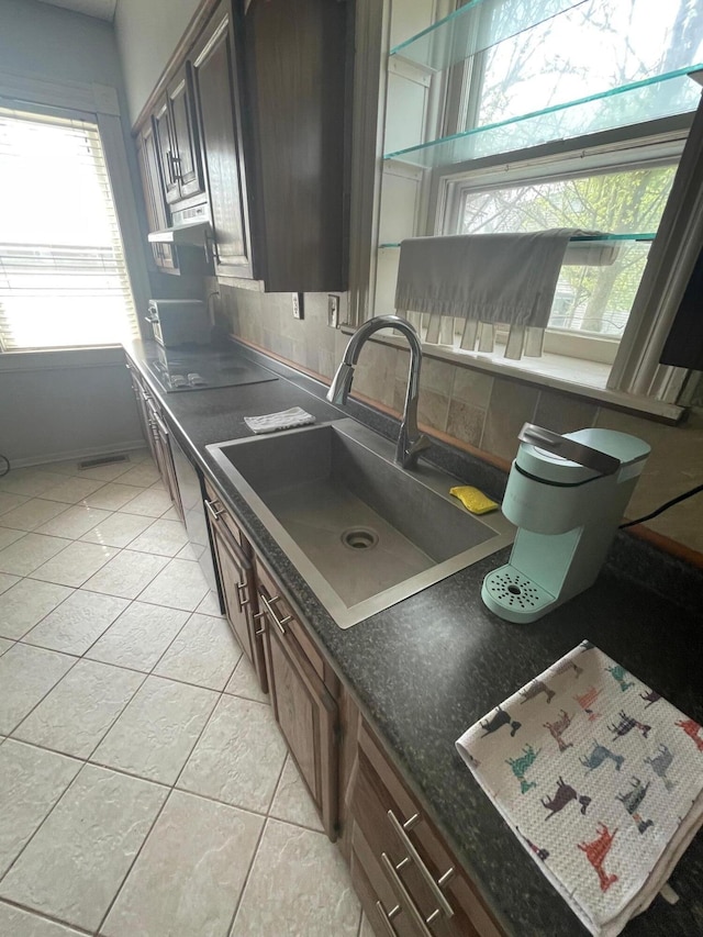142 Old Lafayette Ave, Lexington, KY 40502 - kitchen with black electric stovetop, ventilation hood, light tile patterned flooring, and a sink