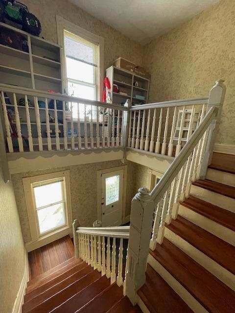 142 Old Lafayette Ave, Lexington, KY 40502 - stairs with baseboards, hardwood / wood-style floors, and wallpapered walls