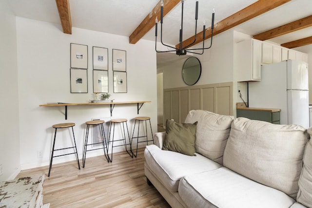 living room with beam ceiling and light wood-style floors