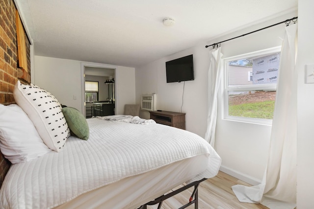bedroom with baseboards and wood finished floors