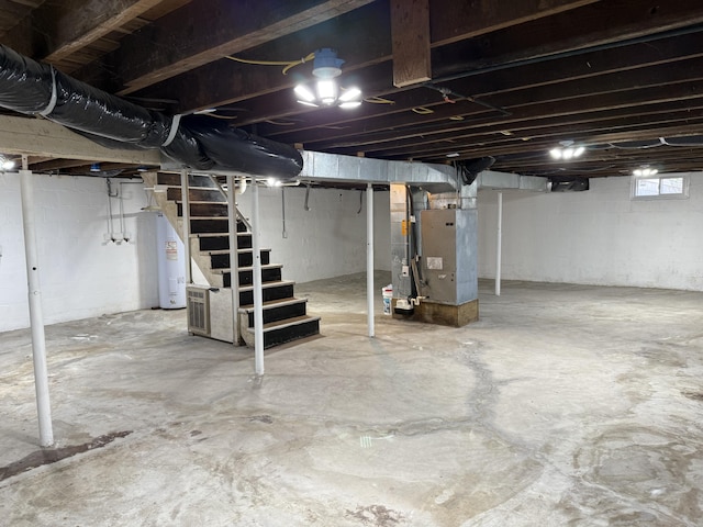 21 N Gregory St, Monticello, KY 42633 - below grade area with heating unit, stairway, and water heater