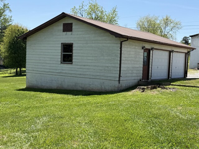 21 N Gregory St, Monticello, KY 42633 - exterior space with a yard, metal roof, and a garage