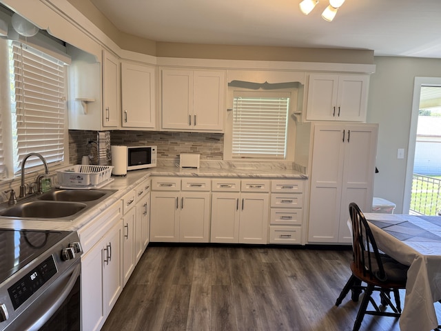 21 N Gregory St, Monticello, KY 42633 - kitchen featuring a sink, white cabinets, and a wealth of natural light