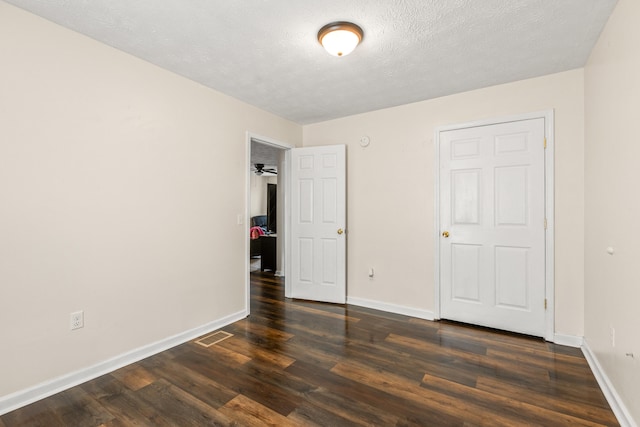 357 Burchwood Dr, Berea, KY 40403 - unfurnished bedroom with visible vents, baseboards, a textured ceiling, and dark wood finished floors
