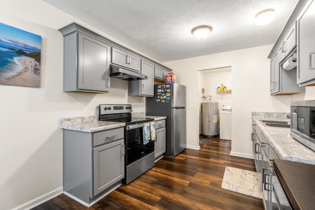 357 Burchwood Dr, Berea, KY 40403 - kitchen with appliances with stainless steel finishes, under cabinet range hood, gray cabinetry, water heater, and washer / dryer
