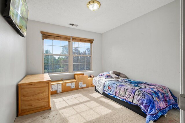 bedroom featuring carpet floors and visible vents