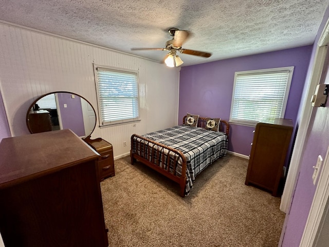 bedroom with a ceiling fan, multiple windows, carpet floors, and baseboards