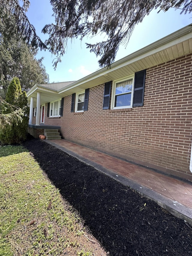view of side of home featuring brick siding