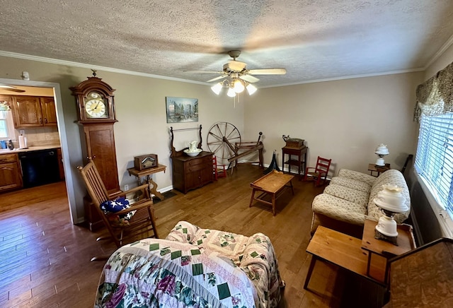 living area with a ceiling fan, wood finished floors, and a healthy amount of sunlight