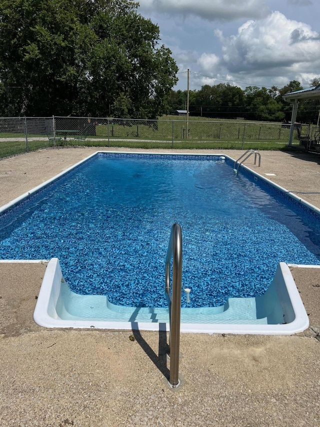 view of swimming pool featuring fence and a fenced in pool