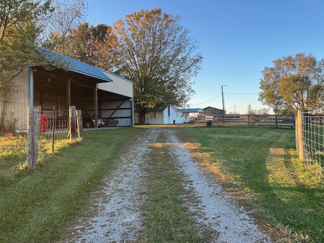exterior space with a pole building and driveway