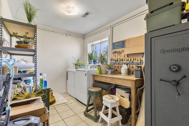 laundry area with laundry area, visible vents, washing machine and dryer, and light tile patterned floors