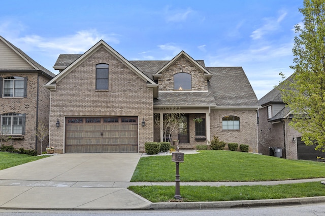 view of front facade featuring an attached garage, driveway, a front lawn, and brick siding