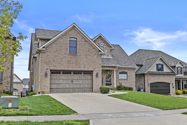 view of front of home featuring a front lawn, brick siding, and driveway