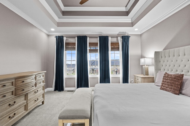 bedroom featuring light colored carpet, crown molding, a tray ceiling, and recessed lighting