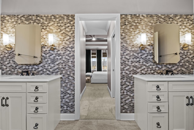 bathroom with two vanities, tasteful backsplash, and a sink