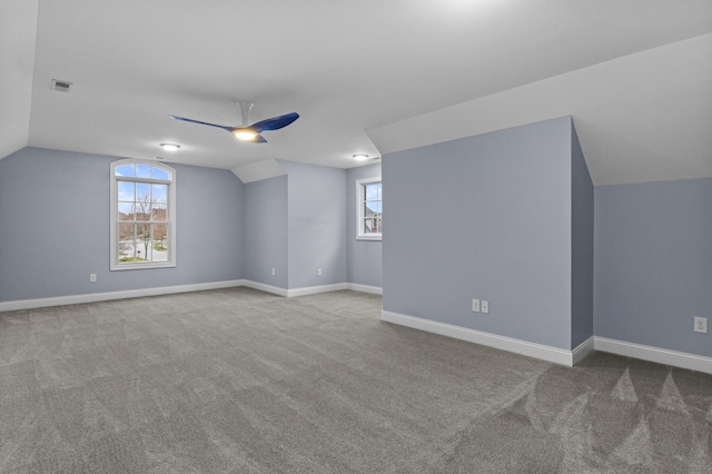 bonus room featuring carpet flooring, vaulted ceiling, baseboards, visible vents, and a ceiling fan
