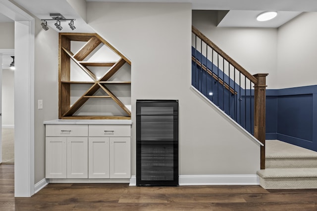 interior space featuring wood finished floors, beverage cooler, and baseboards