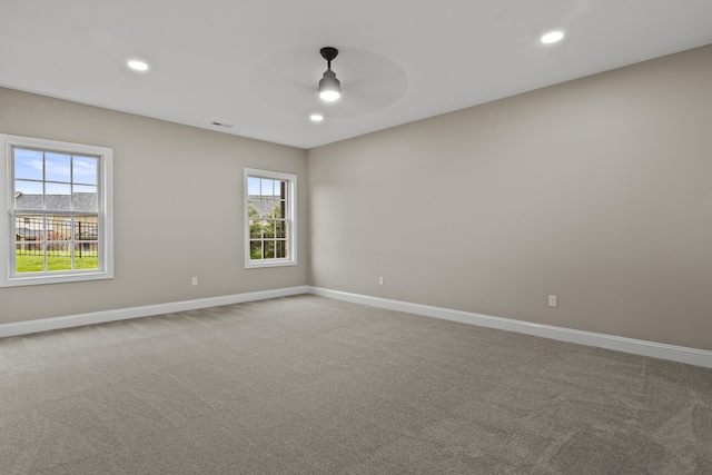 unfurnished room with recessed lighting, a ceiling fan, baseboards, and light carpet