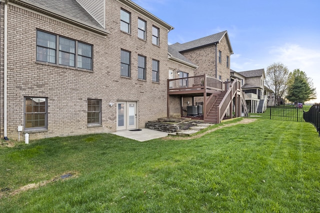 back of house featuring stairway, a fenced backyard, cooling unit, brick siding, and a deck