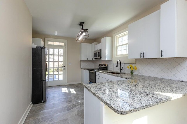 401 E Main St, Danville, KY 40422 - kitchen with a sink, stainless steel appliances, backsplash, baseboards, and white cabinets