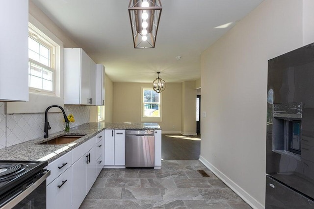 401 E Main St, Danville, KY 40422 - kitchen featuring stone finish flooring, a wealth of natural light, dishwasher, and a sink