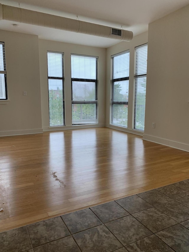 650 S Mill St Unit 218, Lexington, KY 40508 - spare room with wood finished floors, plenty of natural light, and baseboards