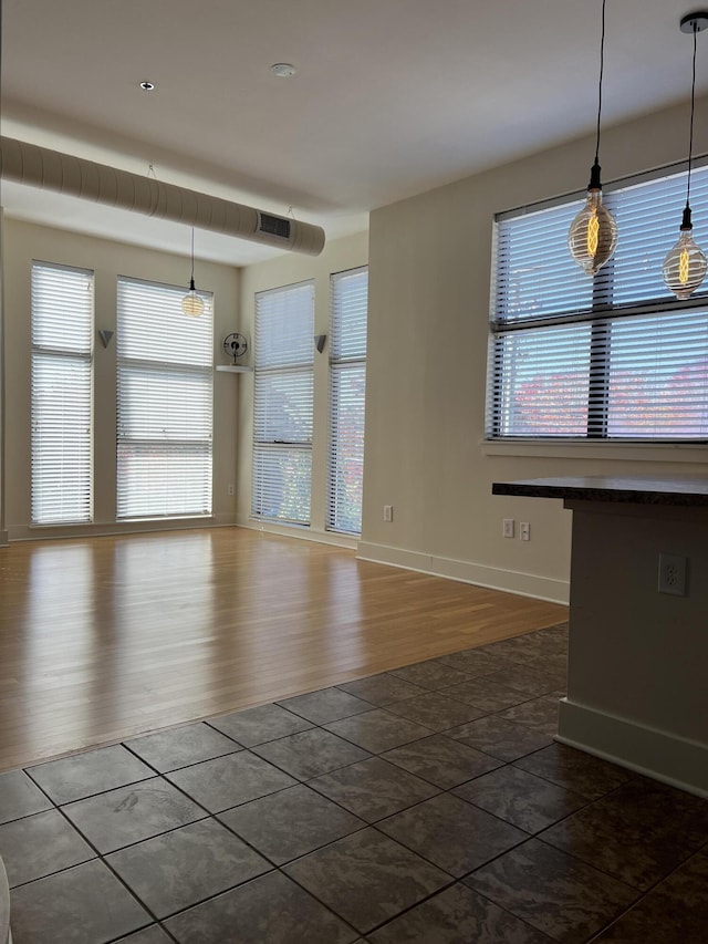 650 S Mill St Unit 218, Lexington, KY 40508 - spare room featuring plenty of natural light, dark tile patterned floors, and baseboards