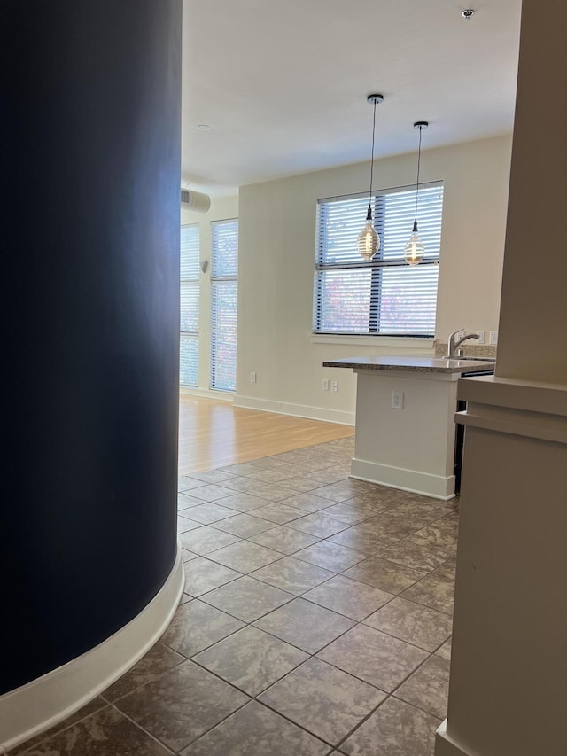 650 S Mill St Unit 218, Lexington, KY 40508 - kitchen featuring light tile patterned floors, decorative light fixtures, baseboards, and a sink