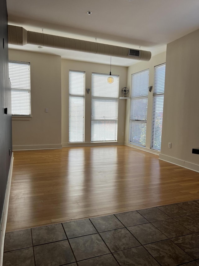 650 S Mill St Unit 218, Lexington, KY 40508 - unfurnished room featuring wood finished floors, plenty of natural light, and baseboards