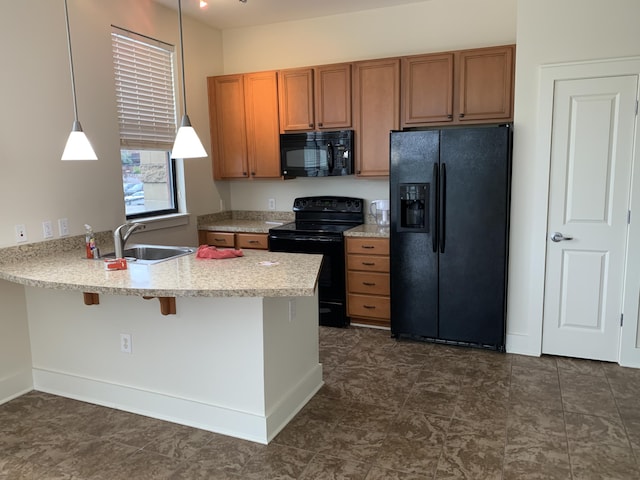 650 S Mill St Unit 218, Lexington, KY 40508 - kitchen with black appliances, a sink, brown cabinetry, and a peninsula