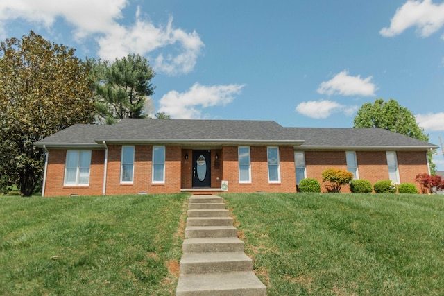 single story home featuring brick siding and a front lawn