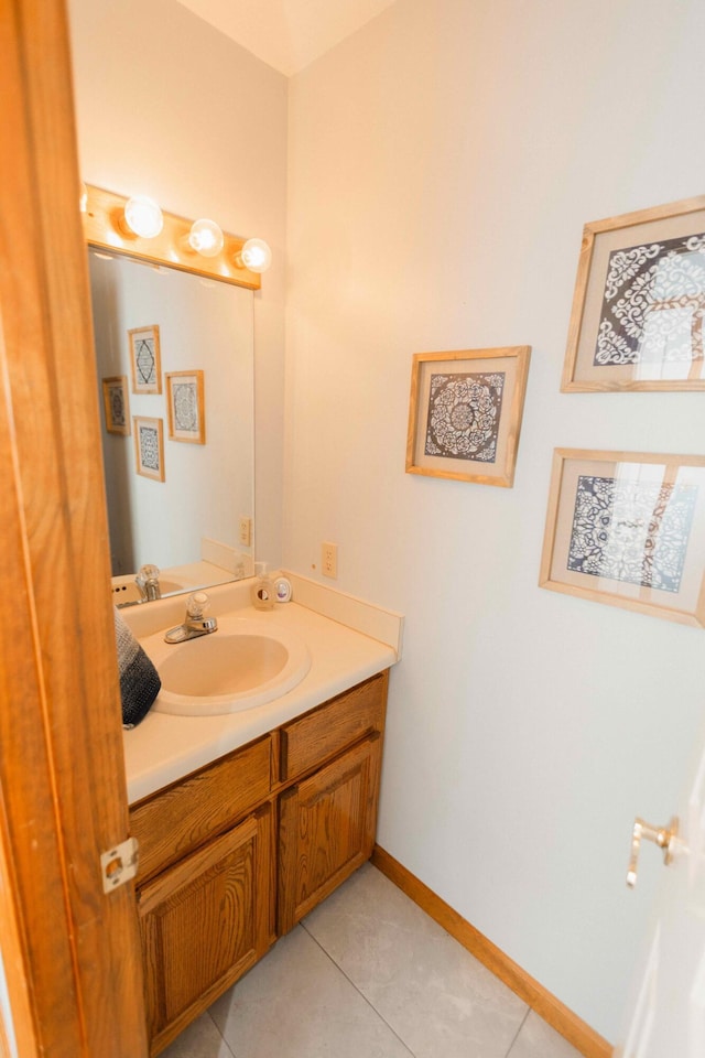 bathroom featuring baseboards, tile patterned floors, and vanity