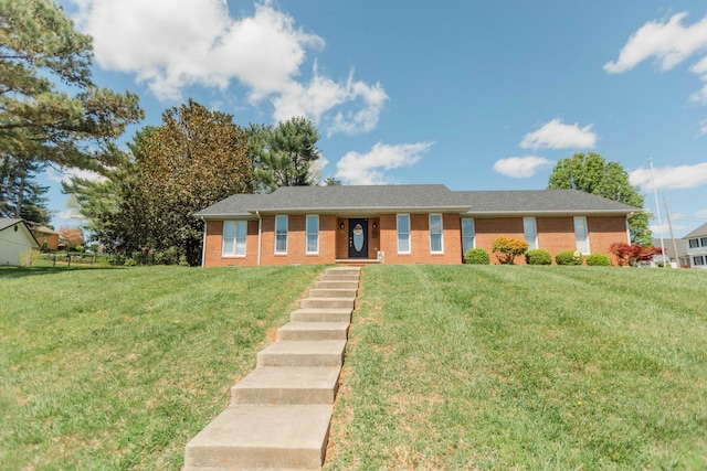 ranch-style house featuring brick siding and a front yard