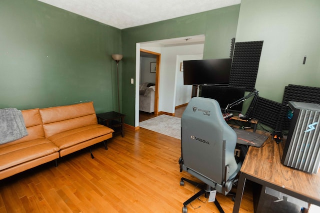 home office featuring baseboards and wood finished floors