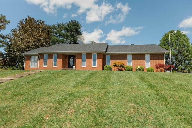 ranch-style home with a front lawn and brick siding