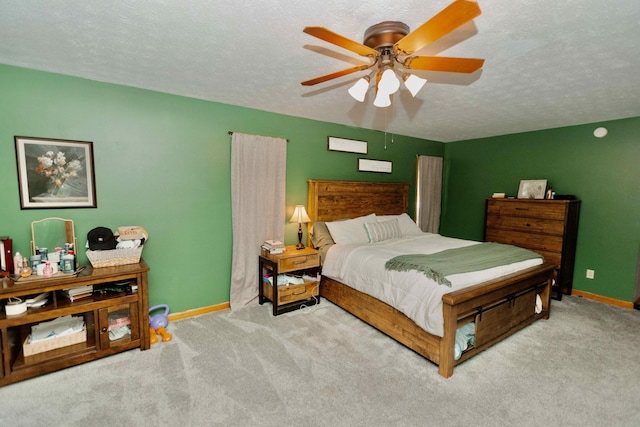 bedroom with baseboards, carpet floors, a textured ceiling, and ceiling fan
