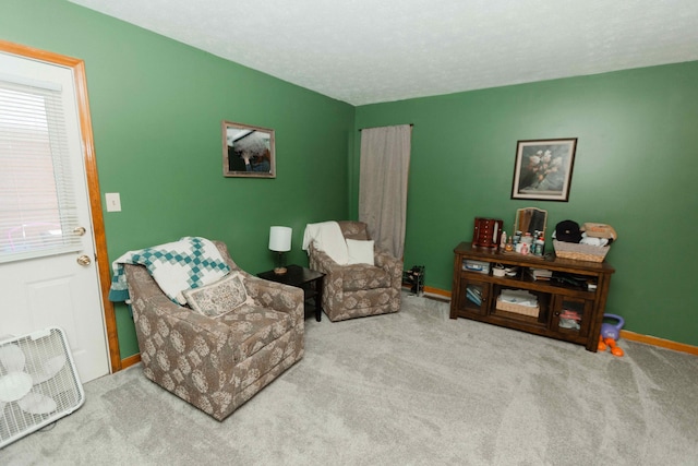 living area featuring carpet floors and a healthy amount of sunlight