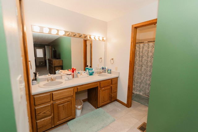 bathroom featuring visible vents, tile patterned flooring, a sink, and double vanity