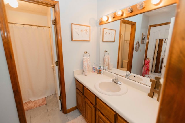 full bathroom with tile patterned flooring, vanity, and toilet