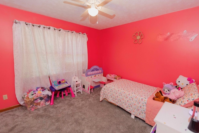 carpeted bedroom featuring a textured ceiling and ceiling fan