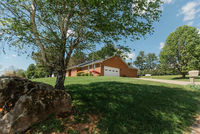 view of home's exterior featuring a lawn, brick siding, and a garage