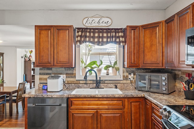 100 Lair St, Mount Vernon, KY 40456 - kitchen featuring stainless steel appliances, a sink, tasteful backsplash, and brown cabinetry