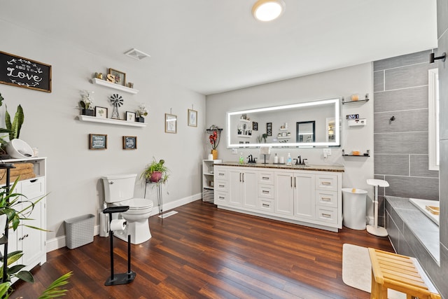 100 Lair St, Mount Vernon, KY 40456 - bathroom featuring double vanity, toilet, wood finished floors, a bath, and baseboards