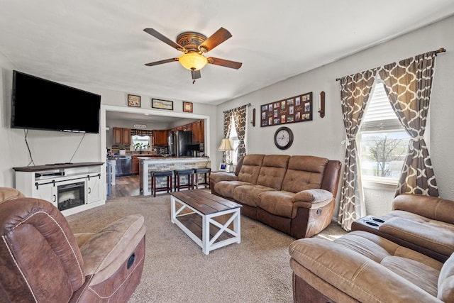 100 Lair St, Mount Vernon, KY 40456 - living room featuring light carpet, a ceiling fan, and a glass covered fireplace